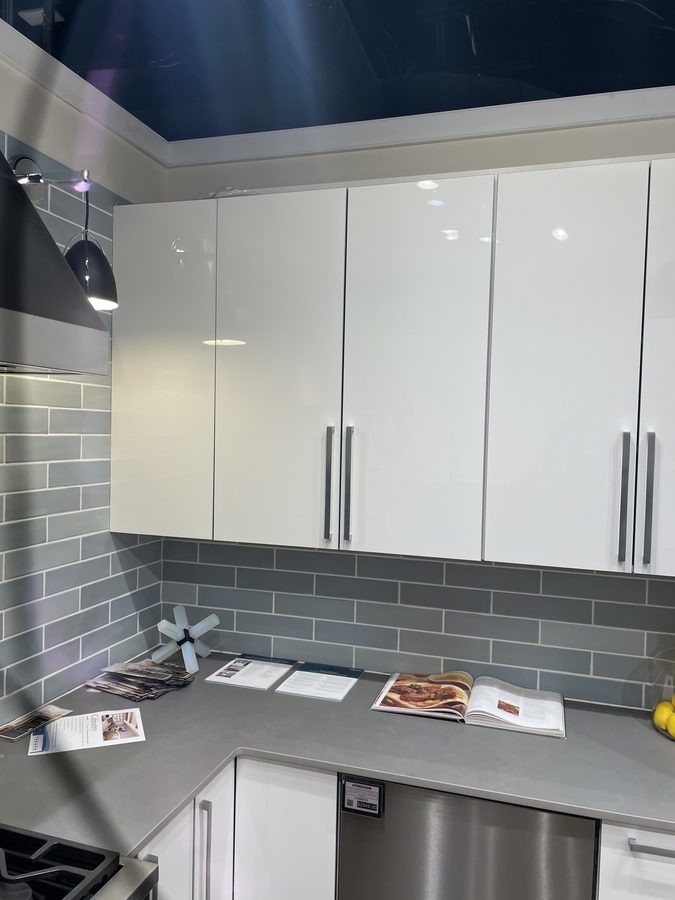 White modern kitchen, angled view showing pendant lighting