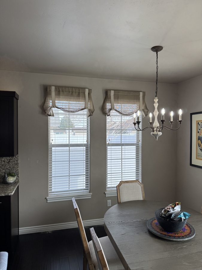 Living room with chandelier and tall windows