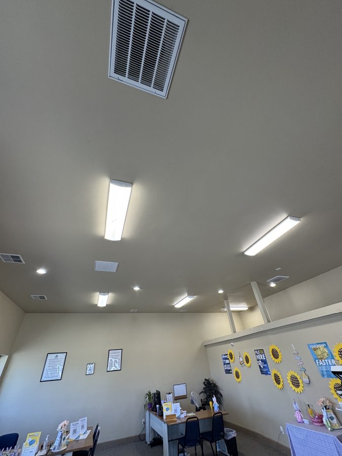 Commercial interior with new fluorescent lighting and exposed ductwork